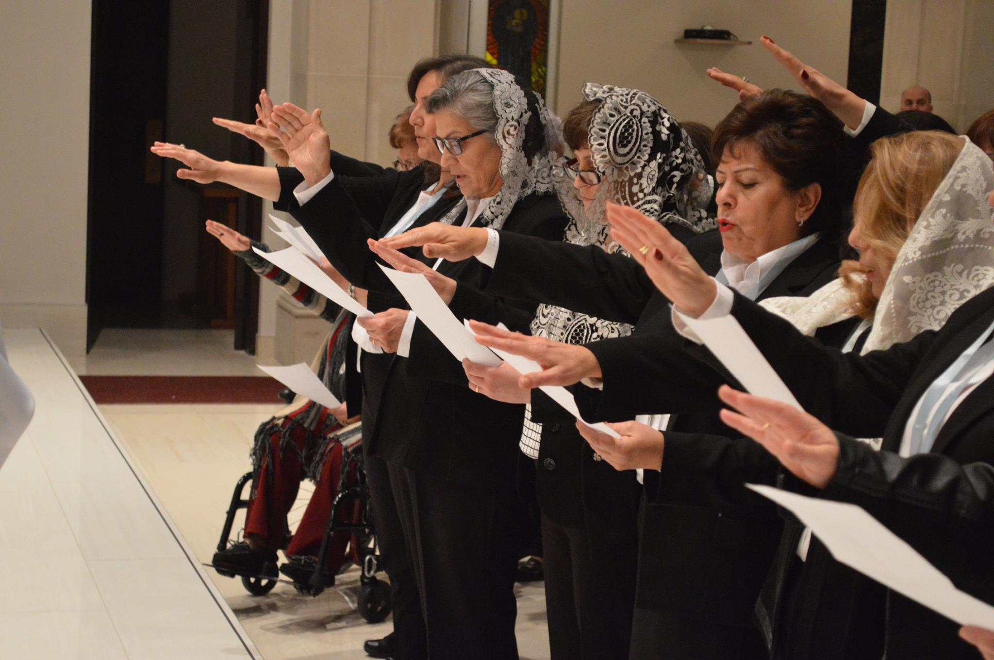 Members praying and taking their oath with veils and mission medallions
