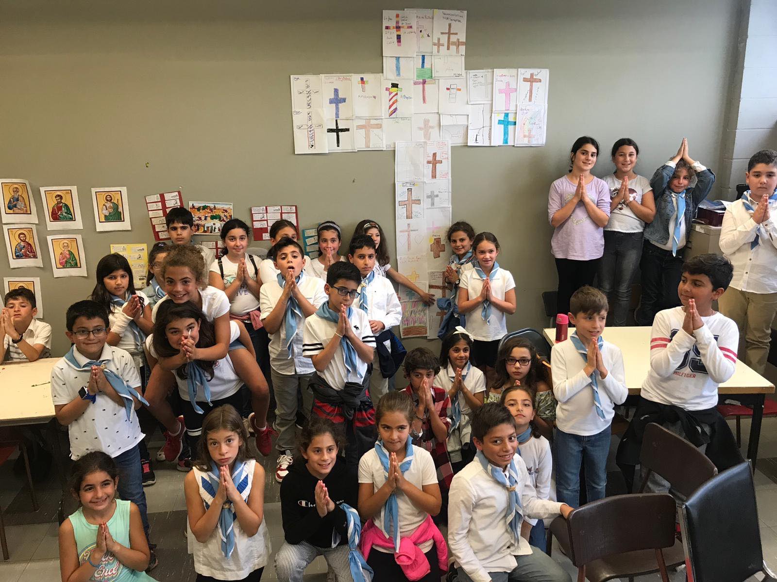 Children praying together during a Fersan classroom session